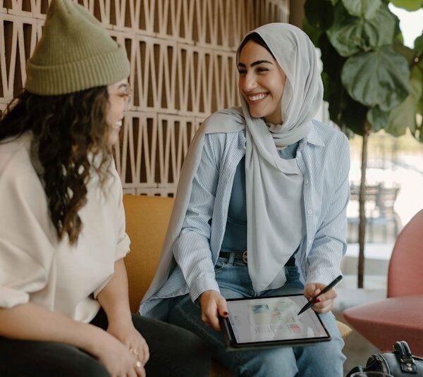 a couple of women sitting on a couch